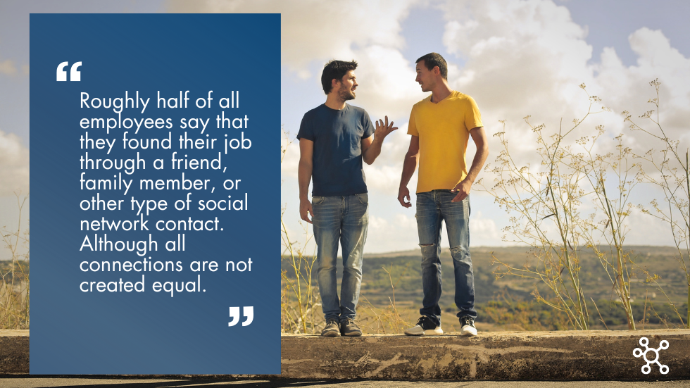 Two men standing in a field having a conversation