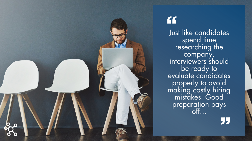Man sitting in a chair on his laptop awaiting an interview