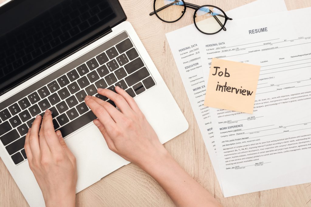 laptop and resume on desk