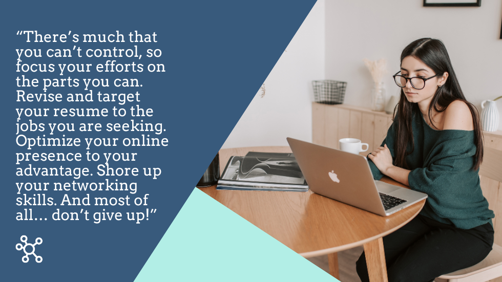 Sad woman sitting alone at a table with her laptop