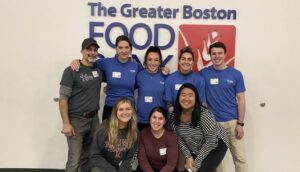 group of Sci.bio employees posing in front of Boston Food Bank sign