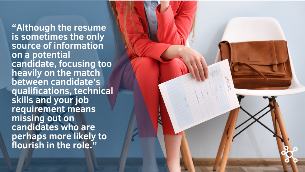 Woman sitting on chair holding resume