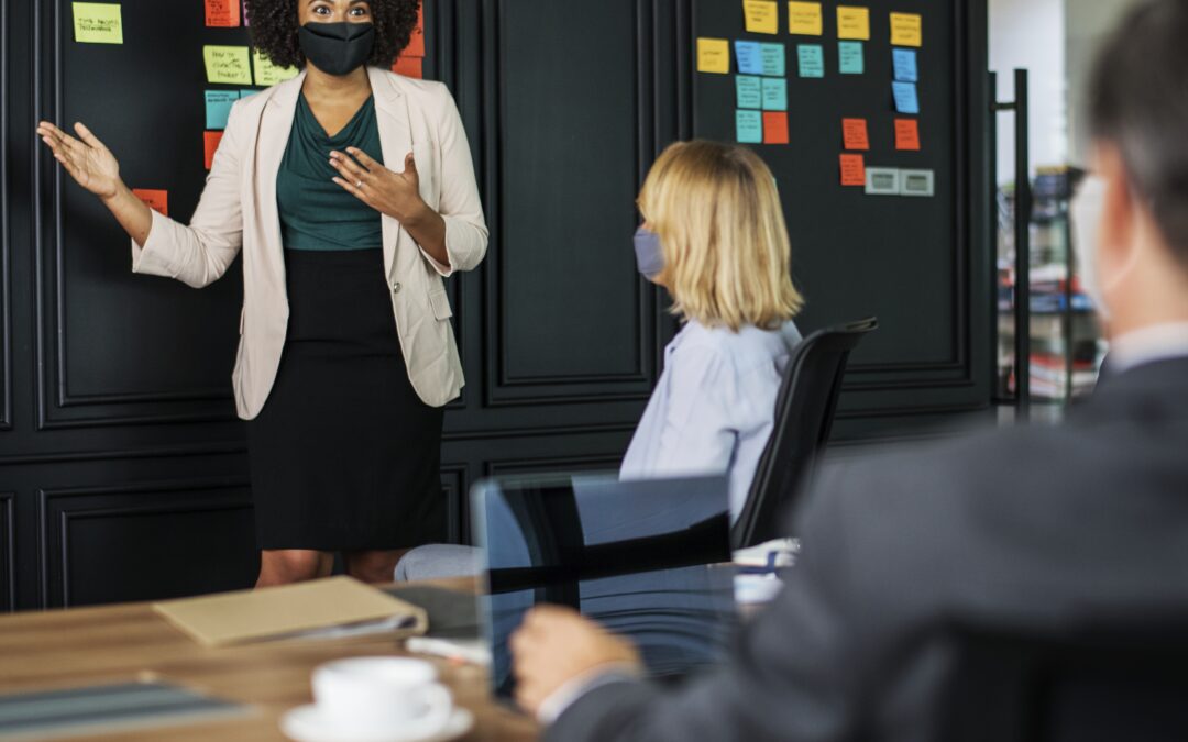 people wearing masks while in a meeting room