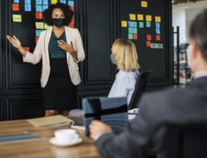 people wearing masks while in a meeting room