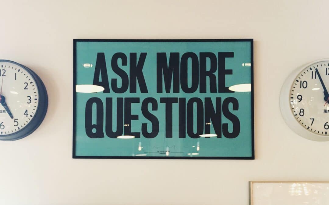 teal sign on wall saying ask more questions