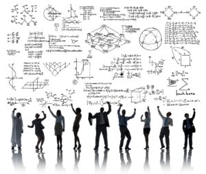 people in front of a large white board with scientific equations