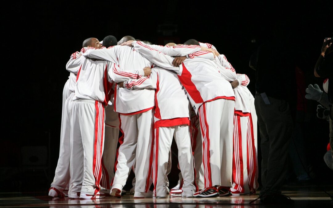 people in white and red suits in huddle