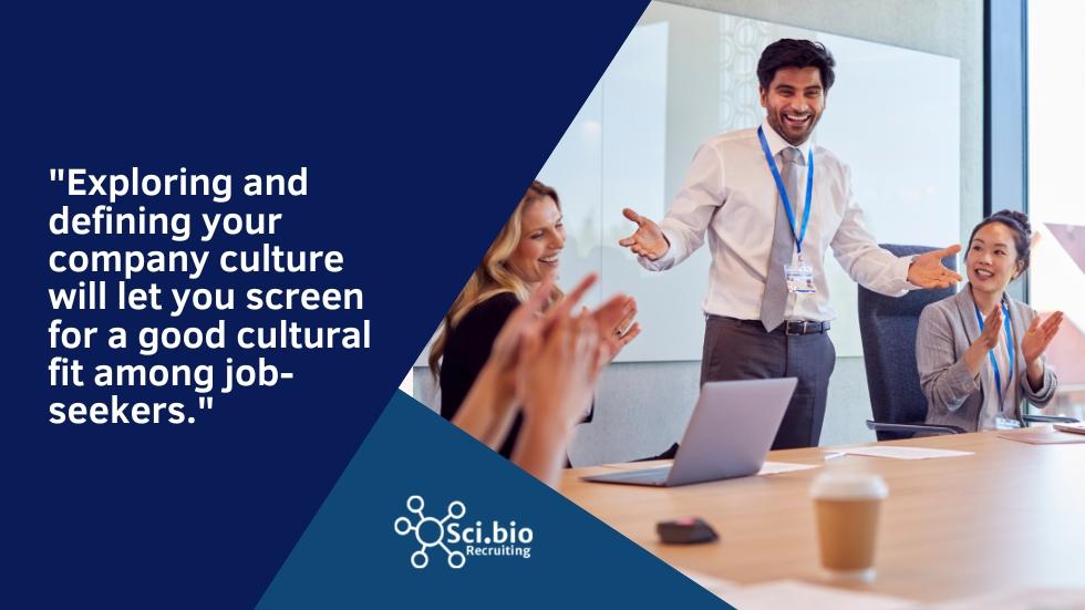 man gesturing towards seated woman for hiring with corporate culture in mind